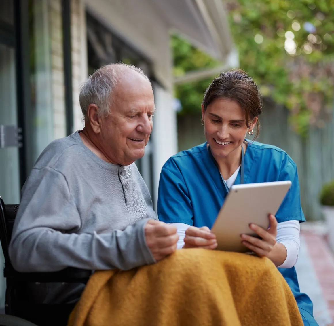 Caregiver and Senior reading from an Ipad – Health Care Services in Delaware County, PA Caregiver and Senior reading from an Ipad - Health Care Services in Delaware County, PA
